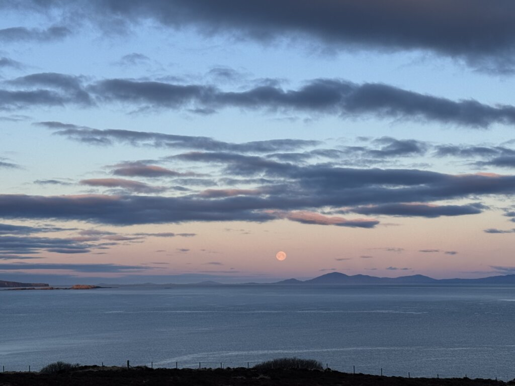 snow moon setting over the hebrides